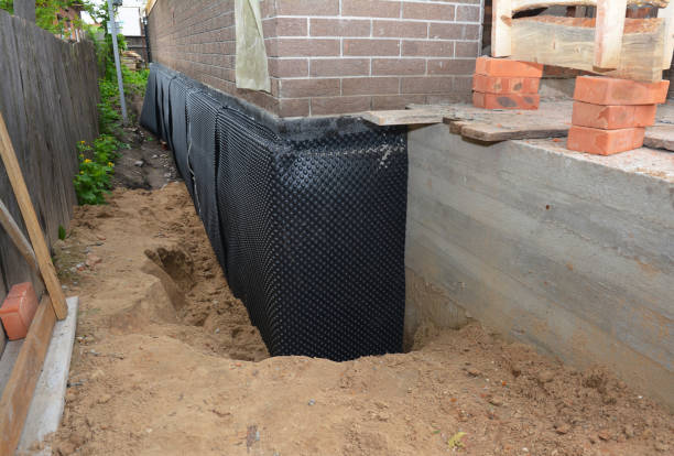 Happy homeowners after waterproofing job in Wales Center